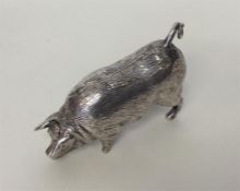 A heavy novelty silver figure of a pig with textur