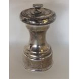 A silver pepper grinder with lift-off cover. Londo