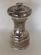 A silver pepper grinder with lift-off cover. Londo