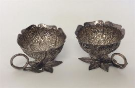 A small pair of Indian cups decorated with flowers