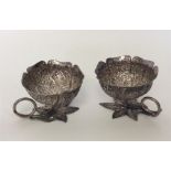 A small pair of Indian cups decorated with flowers