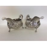 A good pair of Georgian silver embossed sauce boat