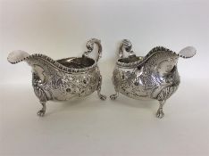 A good pair of Georgian silver embossed sauce boat