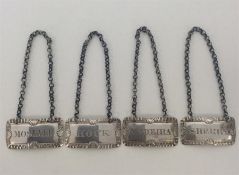 A rare set of four Georgian silver wine labels dep