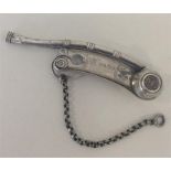 A Victorian silver bright cut whistle with scroll