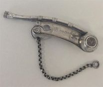 A Victorian silver bright cut whistle with scroll