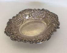 An embossed silver oval pin dish decorated with fl