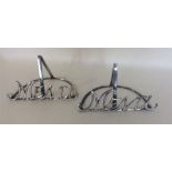A good pair of silver menu holders with scroll mou
