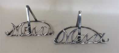 A good pair of silver menu holders with scroll mou