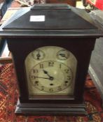 An oak mounted chiming clock.