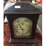 An oak mounted chiming clock.