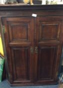 An Antique oak corner cupboard.