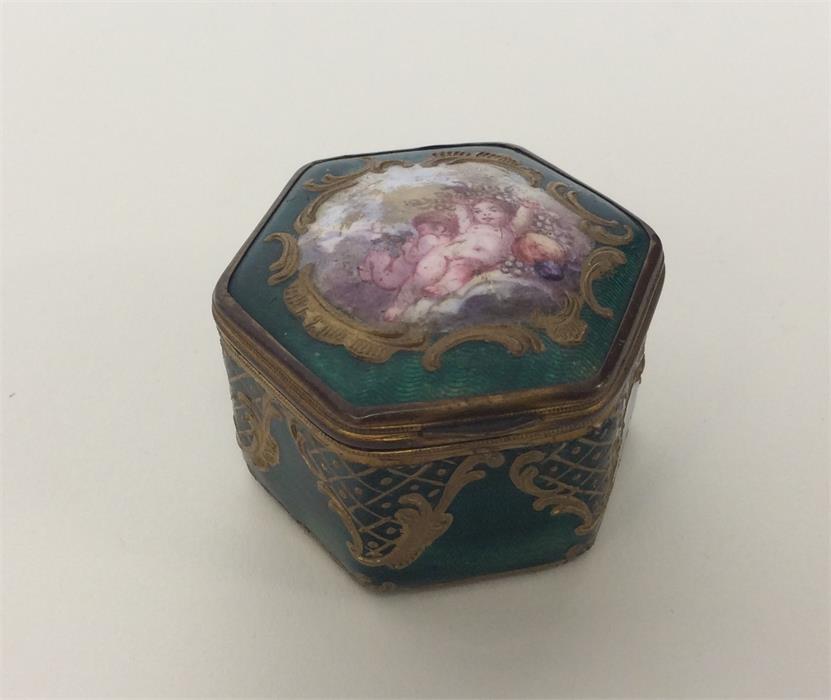 An attractive enamelled box decorated with cherubs