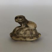 A small signed carved ivory netsuke in the form of