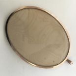 A large silver gilt oval picture frame with loop t