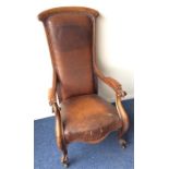 A large high-backed mahogany smokers' chair with s