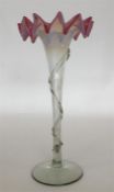 A glass flaring vase with wavy vaseline and ruby r