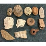 A group of ancient stoneware bottles and figures.