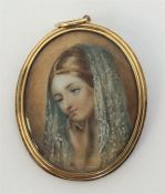 An attractive oval gold miniature of a lady with s