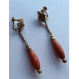 A pair of Antique faceted coral earrings with gold
