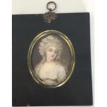 An oval miniature of a lady with wavy hair on a br