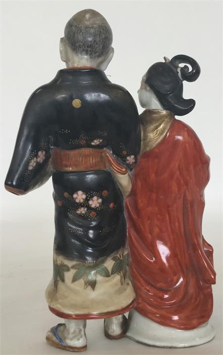 A Japanese porcelain group modelled as a courtesan - Image 2 of 2