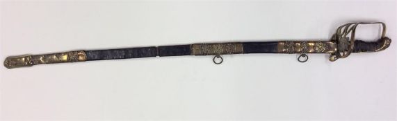 An Antique brass-mounted sword in leather scabbard