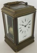 A good brass carriage clock with white enamelled d