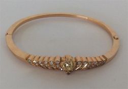 A heavy high carat gold bangle with numerous rows