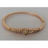 A heavy high carat gold bangle with numerous rows