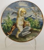A Maiolica plate painted with Cupid seated on a pe