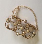A 15 carat pearl and diamond brooch with leaf deco