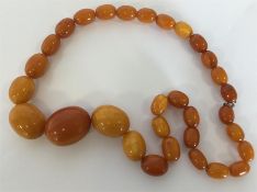 A good graduated string of large amber beads with