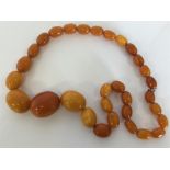 A good graduated string of large amber beads with