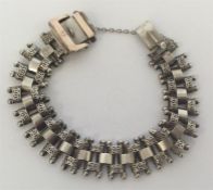 A silver bracelet decorated with balls and piercin