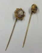 A gold cameo stick pin together with one other. Es