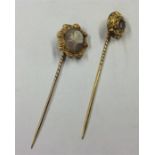 A gold cameo stick pin together with one other. Es