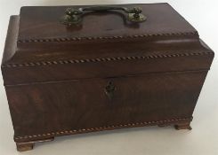 A mahogany tea caddy with hinged top and string in
