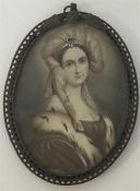 An oval miniature of a lady in brass pierced frame