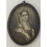 An oval miniature of a lady in brass pierced frame