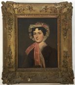 A gilt framed portrait of a lady wearing a bonnet.