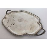 A silver tea tray with gadroon rim and canted corn