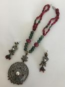 A large ruby and emerald-mounted necklace together
