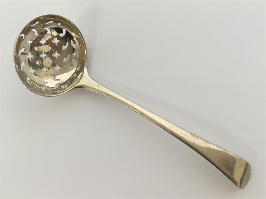 A Georgian silver OE sifter ladle with pierced bow