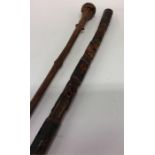 An Eastern tapering walking stick decorated with a