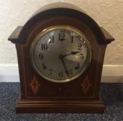 An Edwardian Mahogany dome top clock with striking