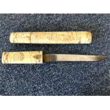 An Antique carved ivory dagger contained within a