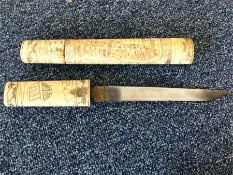 An Antique carved ivory dagger contained within a