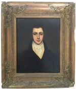 A gilt framed portrait of a gentleman wearing a cr