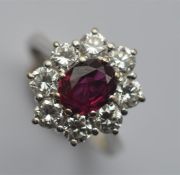 A good quality ruby and diamond oval daisy head cl